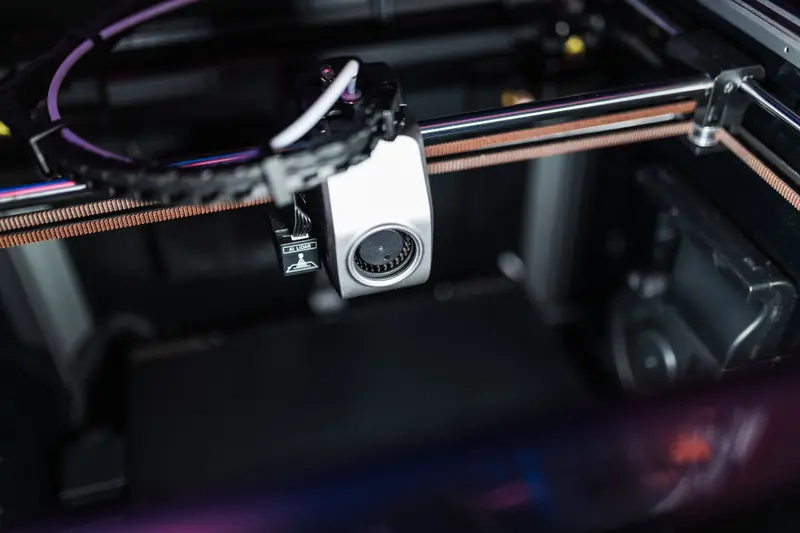 Detailed image showcasing the intricate components of a high-tech 3D printer in action