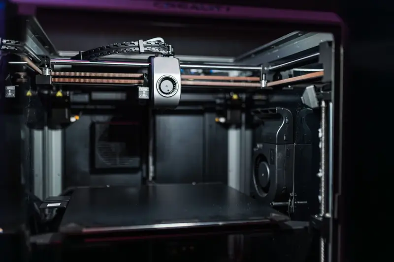 Close-up view of a modern 3D printer interior showcasing advanced technology