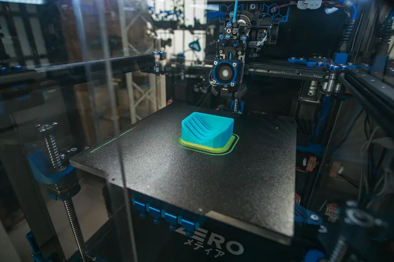 Close-up of a 3D printer creating a plastic object in an industrial setting