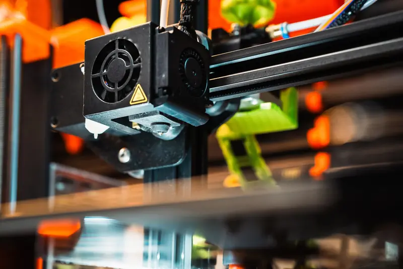 Detailed view of a 3D printer nozzle working in a modern manufacturing setting